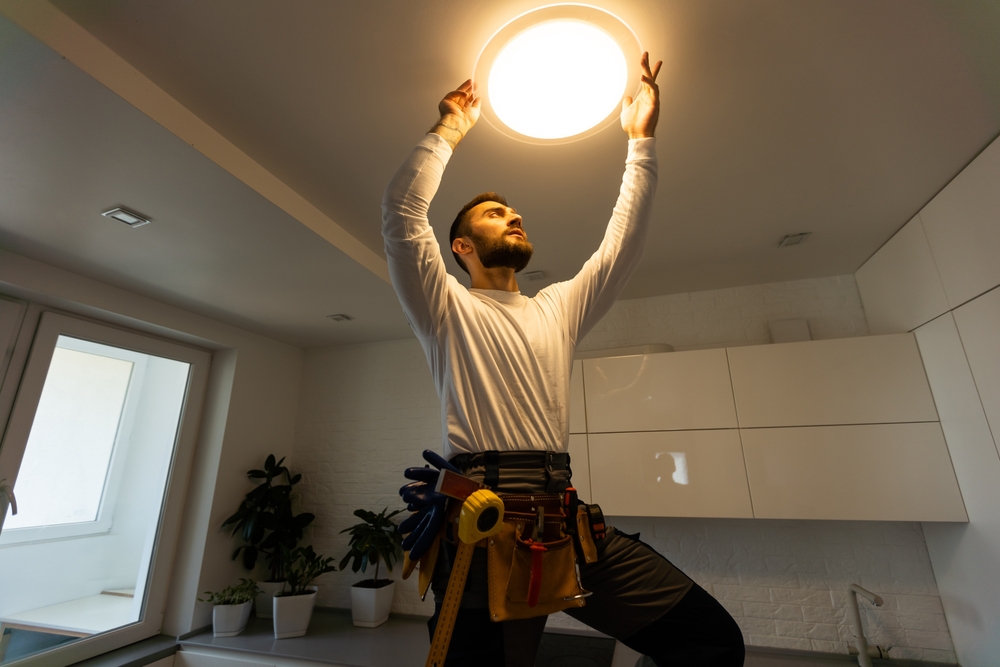 man installing a ceiling light